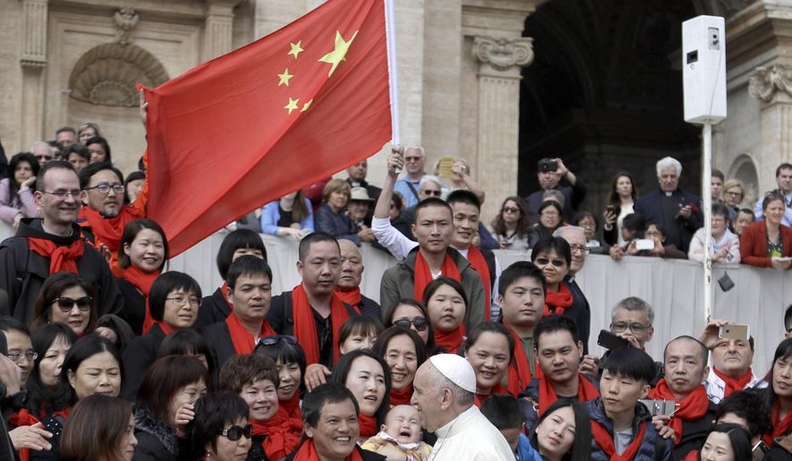FILE - In this April 18, 2018 file photo, Pope Francis meets a group of faithful from China at the end of his weekly general audience in St. Peter&#x27;s Square, at the Vatican. On Saturday, Sept. 22, 2018, the Vatican announced it had signed a &amp;quot;provisional agreement&amp;quot; with China on the appointment of bishops, a breakthrough on an issue that for decades fueled tensions between the Holy See and Beijing and thwarted efforts toward diplomatic relations. (AP Photo/Gregorio Borgia, file)