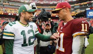 Redskins quarterback Alex Smith was steady in Washington&#x27;s victory on Sunday, while friend and Green Bay Packers quarterback Aaron Rodgers was hampered by an injury. (ASSOCIATED PRESS)