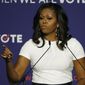 Former first lady Michelle Obama speaks at a rally to encourage voter registration Sunday, Sept. 23, 2018, in Las Vegas. (AP Photo/John Locher)