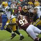 Green Bay Packers quarterback Aaron Rodgers (center) runs the ball against Washington Redskins defensive end Jonathan Allen (93) during an NFL football game between the Green Bay Packers and the Washington Redskins, Sunday, Sept. 23, 2018, in Landover, Md. (AP Photo/Mark Tenally) **FILE**