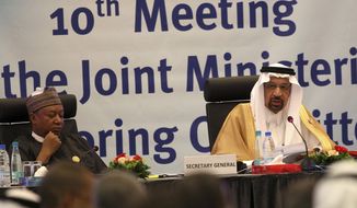 Khalid Al-Falih, Minister of Energy, Industry and Mineral Resources of Saudi Arabia, right, and Mohammed Sanusi Barkindo, OPEC Secretary-General, left, speak during OPEC&#x27;s 10th meeting of the Joint Ministerial Committee to monitor the oil production reduction agreement of the Organization of the Petroleum Exporting Countries, OPEC, and non-OPEC members, in Algiers, Algeria, Sunday, Sept. 23, 2018. (AP Photo/Anis Belghoul)