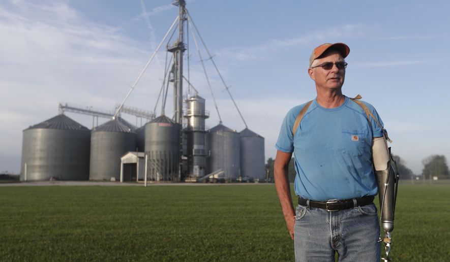 Jack Maloney poses in front of the grain bins on his Little Ireland Farms in Brownsburg, Ind., Wednesday, Sept. 12, 2018. Maloney, who farms about 2,000 acres in Hendricks Count, said the aid for farmers is &amp;quot;a nice gesture&amp;quot; but what farmers really want is free trade, not government handouts. American farmers will soon begin getting checks from the government as part of a billion-dollar bailout to help those experiencing financial strain from President Donald Trump’s trade disputes with China(AP Photo/Michael Conroy)