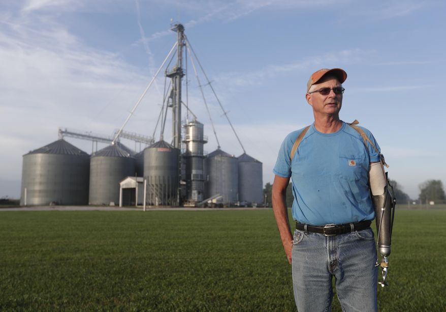 Jack Maloney poses in front of the grain bins on his Little Ireland Farms in Brownsburg, Ind., Wednesday, Sept. 12, 2018. Maloney, who farms about 2,000 acres in Hendricks Count, said the aid for farmers is "a nice gesture" but what farmers really want is free trade, not government handouts. American farmers will soon begin getting checks from the government as part of a billion-dollar bailout to help those experiencing financial strain from President Donald Trump’s trade disputes with China(AP Photo/Michael Conroy)