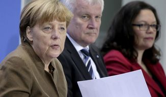 FILE -- In this Thursday, April 14, 2016 photo, from left, German Chancellor Angela Merkel, Horst Seehofer, Chairman of the German Christian Social Union and Andrea Nahles, Chairwomen of the German Social Democrats, address the media during a press conference in Berlin. The leaders of German Chancellor Angela Merkel&#39;s governing coalition were trying Sunday to resolve a standoff over the future of the country&#39;s domestic intelligence chief and stabilize their six-month-old alliance. (AP Photo/Michael Sohn)