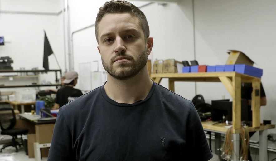 FILE - In this Aug. 1, 2018, file photo, Cody Wilson, with Defense Distributed, holds a 3D-printed gun called the Liberator at his shop, in Austin, Texas. Authorities in Taiwan have arrested Wilson who is wanted in the U.S. over an accusation that he had sex with an underage girl and paid her $500 afterward, official media reported. (AP Photo/Eric Gay, File)