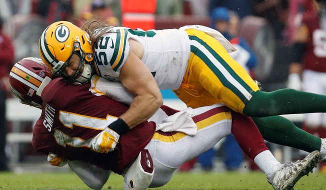 Washington Redskins quarterback Alex Smith was sacked by Green Bay Packers linebacker Clay Matthews on Sunday. Matthews was called for a roughing-the-passer penalty on the play. (ASSOCIATED PRESS)