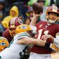 Washington Redskins quarterback Alex Smith (11) passes the ball as he&#x27;s hit by Green Bay Packers linebacker Clay Matthews (52) during the first half of an NFL football game, Sunday, Sept. 23, 2018 in Landover, Md. (AP Photo/Alex Brandon) (ASSOCIATED PRESS)