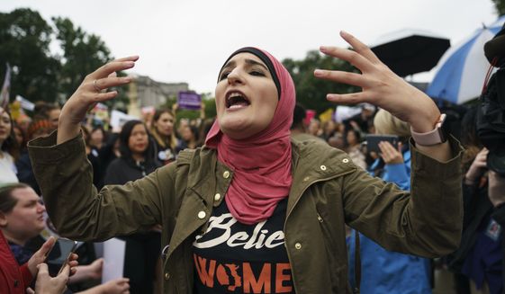 In this file photo, Linda Sarsour with Women&#39;s March calls out to other activists opposed to President Donald Trump&#39;s embattled Supreme Court nominee, Brett Kavanaugh, in front of the Supreme Court on Capitol Hill in Washington, Monday, Sept. 24, 2018. (AP Photo/Carolyn Kaster) ** FILE **