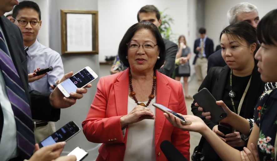 Sen. Mazie Hirono, D-Hawaii, center talks with reporters, on Capitol Hill, Monday, Sept. 24, 2018 in Washington.  (AP Photo/Alex Brandon)