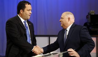 Maryland Democratic gubernatorial candidate Ben Jealous, left, and Republican candidate, Maryland Gov. Larry Hogan, shake hands before participating in a debate Monday, Sept. 24, 2018, at Maryland Public Television&#39;s studios in Owings Mills, Md. (AP Photo/Patrick Semansky)