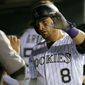 Colorado Rockies&#39; Gerardo Parra is congratulated by teammates in the dugout after scoring a run against the Philadelphia Phillies during the sixth inning of a baseball game on Monday, Sept. 24, 2018, in Denver. (AP PhotoJack Dempsey) **FILE**