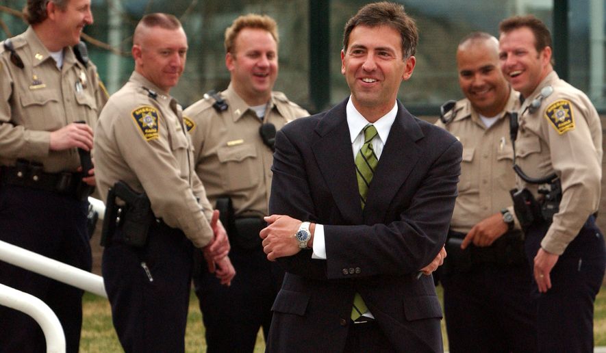 Attorney for the alleged victim in the Kobe Bryant sexual assault case, John Clune, center, laughs as he chats with members of the Eagle County Sheriffs department outside the Eagle County Courthouse, Wednesday March 24, 2004, in Eagle, Colorado. Clune&#39;s client testified about her sex life for more than three hours Wednesday during a closed-door hearing that will determine whether any of the information can be introduced at the NBA star&#39;s rape trial. (AP Photo/Peter Fredin)