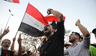 Demonstrators wave national flags and chant slogans during a demonstration demanding better public services and jobs in the southern city of Basra, Iraq, Tuesday, Sept. 25, 2018. (AP Photo/Nabil al-Jurani) ** FILE **