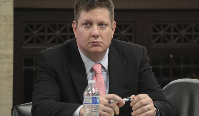 Chicago police officer Jason Van Dyke listens during his trial for the shooting death of Laquan McDonald at the Leighton Criminal Court Building in Chicago on Monday, Sept. 24, 2018. Lawyers for the white Chicago police officer charged with murder in the shooting of McDonald, a black teenager, opened their defense case Monday with a witness questioning the thoroughness and accuracy of the autopsy. (Antonio Perez/Chicago Tribune via AP, Pool)