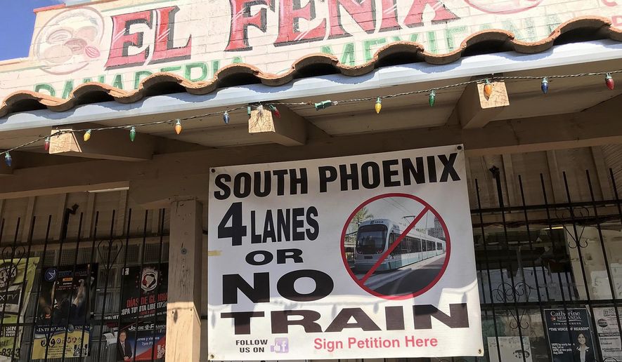In this Wednesday, Sept. 5, 2018, photo, a local business displays a protest sign of the proposed extension of the light rail system along Central Avenue, in Phoenix. The proposed extension of Phoenix’s light-rail system into the city’s poorest neighborhood is running into eleventh-hour opposition from some business owners in the Hispanic and black community.(AP Photo/Anita Snow)