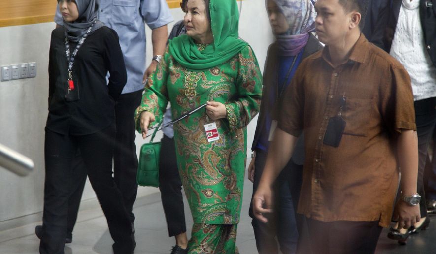 Rosmah Mansor, center, wife of former Malaysian Prime Minister Najib Razak, arrives at Anti-Corruption Agency for questioning in Putrajaya, Wednesday, Sept. 26, 2018. Rosmah has already been questioned by the anti-corruption investigators last June about alleged theft and money-laundering involving the 1MDB state investment fund. (AP Photo/Yam G-Jun)
