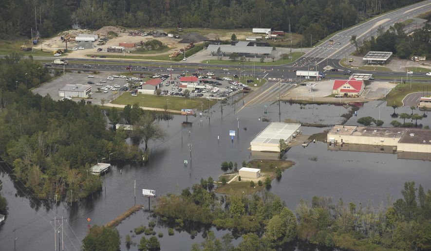 In this Monday, Sept. 24, 2018 photo, flood waters from the Neuse River cover the area a week after Hurricane Florence in Kinston, N.C. Monday Sept. 24, 2018.  (Ken Blevins/The Star-News via AP)