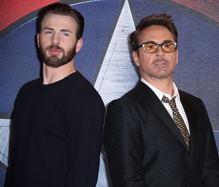 Chris Evans, left and Robert Downey Jr. pose for photographers at the photo call of the film 'Captain America Civil War' in London, Monday, April 25, 2016. (Photo by Joel Ryan/Invision/AP)-
