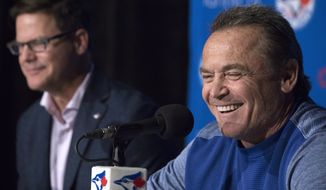 Toronto Blue Jays manager John Gibbons smiles alongside Blue Jays general manager Ross Atkins, left, during a press conference in Toronto, Wednesday, Sept. 26, 2018. Gibbons will not return to the Toronto Blue Jays in 2019, ending his second run with the club. The Blue Jays made the long-expected announcement on Wednesday, ahead of Toronto&#x27;s final home game of the season against the Houston Astros. (Chris Young/The Canadian Press via AP)
