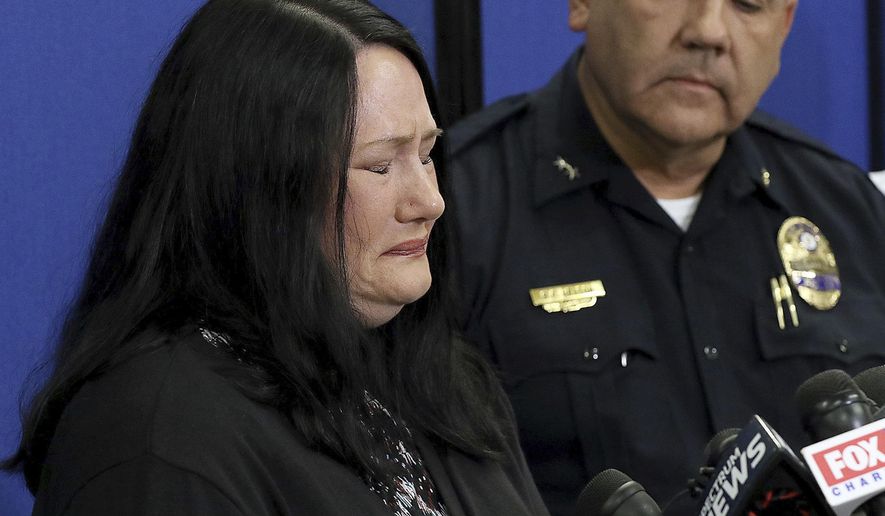 Carrie Ritch cries as Gastonia Police Chief Robert Helton stands with her during a news conference, Tuesday, Sept. 25, 2018, in Gastonia, N.C., as she talks about her 6-year-old son Maddox Ritch who went missing Saturday, Sept. 22, from Rankin Lake Park in Gastonia. The FBI has joined the search. (John Clark/The Gaston Gazette via AP)