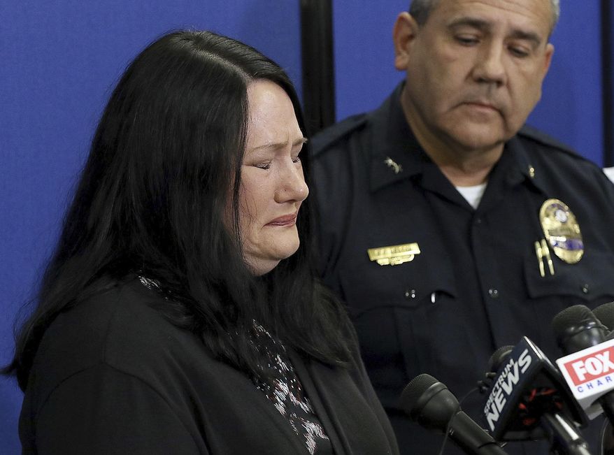 Carrie Ritch cries as Gastonia Police Chief Robert Helton stands with her during a news conference, Tuesday, Sept. 25, 2018, in Gastonia, N.C., as she talks about her 6-year-old son Maddox Ritch who went missing Saturday, Sept. 22, from Rankin Lake Park in Gastonia. The FBI has joined the search. (John Clark/The Gaston Gazette via AP)