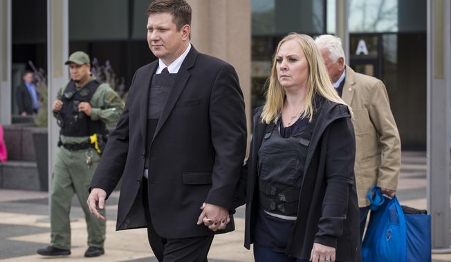 Chicago Police Officer Jason Van Dyke holds hands with his wife Tiffany Van Dyke as he walks out of the Leighton Criminal Courthouse, Wednesday, Sept. 26, 2018 in Chicago. (Ashlee Rezin/Chicago Sun-Times via AP)
