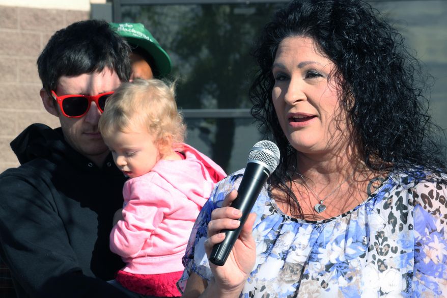 Annette Torres, a single mother, talks about her struggles paying for child care during a news conference in Albuquerque, N.M., on Wednesday, Sept. 26, 2018. Torres is among a group of plaintiffs suing the New Mexico Children, Youth and Families Department over what they say are illegal regulations that have resulted in low-income families being denied child care assistance. (AP Photo/Susan Montoya Bryan)