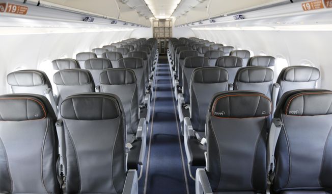 FILE - This Thursday, March 16, 2017, file photo shows the interior of a commercial airliner at John F. Kennedy International Airport in New York. On Wednesday, Sept. 26, 2018, the House voted to direct the federal government to set a minimum size for airline seats, bar passengers from being kicked off overbooked planes, and consider whether to restrict animals on planes. (AP Photo/Seth Wenig, File)