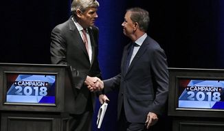Republican Party candidate Bob Stefanowski, left, shakes hands with Democratic Party candidate Ned Lamont, at the end of a gubernatorial debate at the University of Connecticut in Storrs, Conn., Wednesday, Sept. 26, 2018. (AP Photo/Jessica Hill)