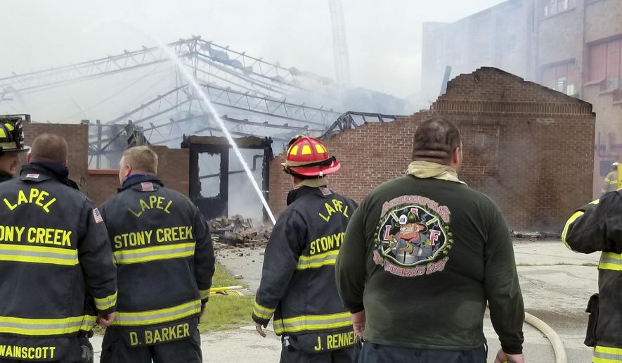 This photo provided by the Indiana Department of Correction shows firefighters working extinguish a fire Wednesday, Sept. 26, 2018, at Indiana's Pendleton Correctional Facility in Pendleton, Ind., that heavily damaged one of the prison complex's buildings. No inmates or staff were injured in the fire. (Indiana Department of Correction via AP)
