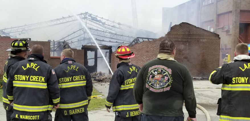 This photo provided by the Indiana Department of Correction shows firefighters working extinguish a fire Wednesday, Sept. 26, 2018, at Indiana's Pendleton Correctional Facility in Pendleton, Ind., that heavily damaged one of the prison complex's buildings. No inmates or staff were injured in the fire. (Indiana Department of Correction via AP)