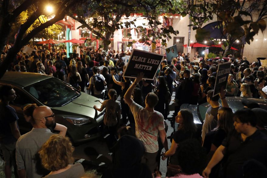 FILE - In this Sept. 15, 2017 file photo, protesters gather, in St. Louis, after a judge found Jason Stockley, a white former St. Louis police officer, not guilty of first-degree murder in the death of Anthony Lamar Smith, a black man, who was fatally shot following a high-speed chase in 2011. Democratic Alderwoman Megan Ellyia Green, who joined the protests after Stockley was acquitted of murder last year in the shooting of Smith, is suing police response to the demonstrations. (AP Photo/Jeff Roberson, File)
