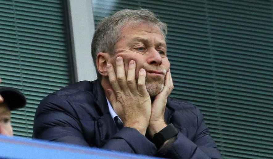 In this Saturday, Dec. 19, 2015, file photo, Chelsea soccer club owner Roman Abramovich sits in his box before the English Premier League soccer match between Chelsea and Sunderland at Stamford Bridge stadium in London. Roman Abramovich withdrew an application for residency in Switzerland, according to the Swiss migration office, as lawyers for the Russian oligarch lashed out at “defamatory” allegations involving money laundering and denied that he has links to organized crime. (AP Photo/Matt Dunham, File)