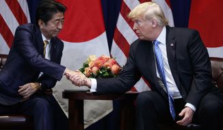 President Donald Trump shakes hands with Japanese Prime Minister Shinzo Abe at the Lotte New York Palace hotel during the United Nations General Assembly, Wednesday, Sept. 26, 2018, in New York. (AP Photo/Evan Vucci)