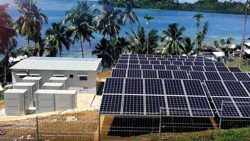 This undated product image provided by NantEnergy shows zinc-air batteries in cabinets at left in a village in Papua, Indonesia. California-based NantEnergy said Wednesday, Sept. 26, 2018, that it has created a rechargeable zinc-air battery storage system that can provide power at a lower cost than lithium-ion systems. (NantEnergy via AP)