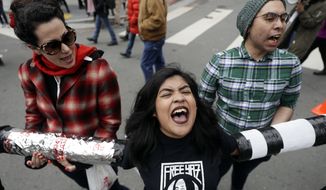 Demonstrators yell slogans as they block an intersection outside of the Immigration and Customs Enforcement offices in San Francisco. (AP Photo/Marcio Jose Sanchez, File)