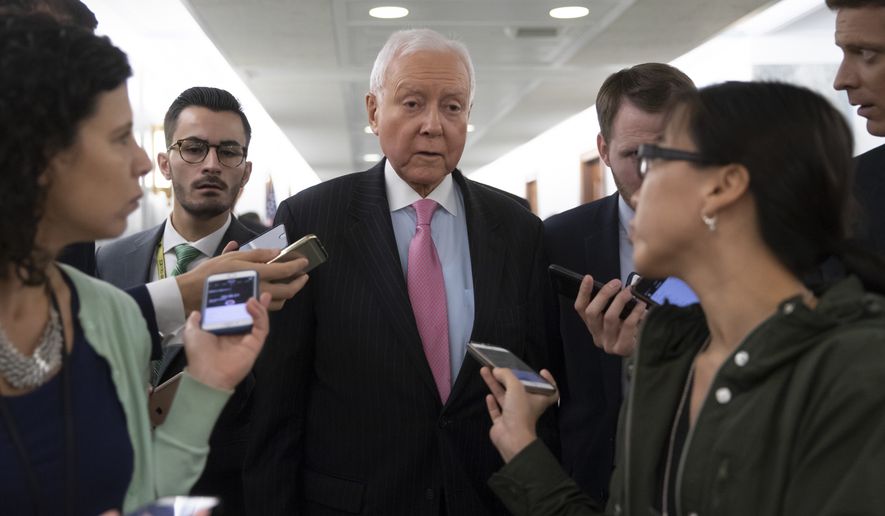 Sen. Orrin Hatch, R-Utah, a senior member of the Senate Judiciary Committee, is surrounded by reporters during a break as they hearing testimony from Christine Blasey Ford on Capitol Hill in Washington, Thursday, Sept. 27, 2018. (AP Photo/J. Scott Applewhite)