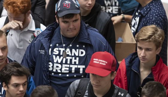 Supporters of Supreme Court nominee Brett Kavanaugh walk through the Hart Senate Office Building as the Senate Judiciary Committee hears from Kavanaugh and Christine Blasey Ford on Capitol Hill in Washington, Thursday, Sept. 27, 2018. (AP Photo/J. Scott Applewhite)