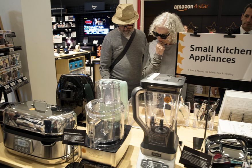 Shoppers browse the items on display at the Amazon 4-star store in the Soho neighborhood of New York, Thursday, Sept. 27, 2018. Amazon is expanding its physical presence again, this time opening a 4,000-square-foot store that sells a wide range of products, including shower curtains, Hallmark cards and baby bottles. (AP Photo/Mary Altaffer)