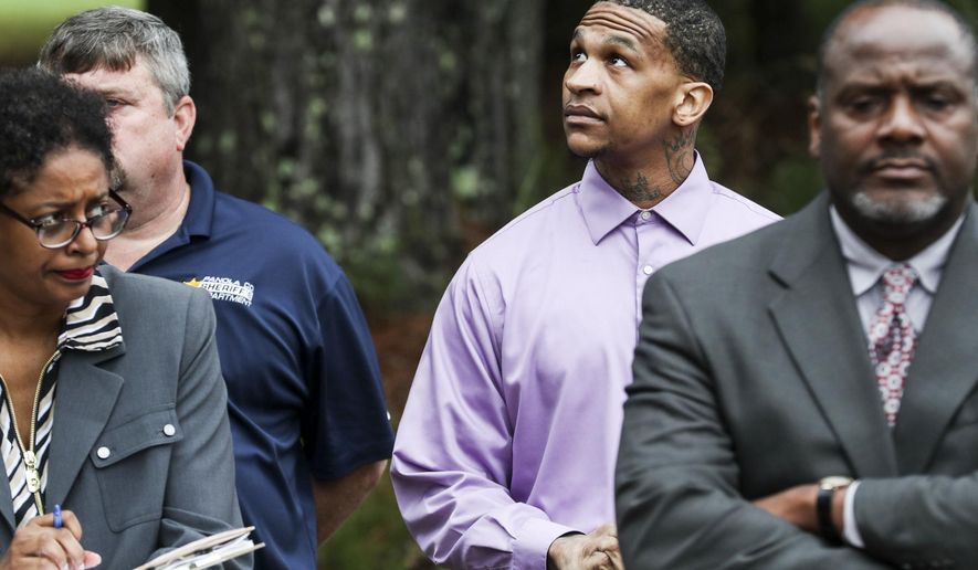 Defendant Quinton Tellis, center, looks around during a court field trip to the crime scene in Courtland, Miss. on Thursday, Sept.27, 2018. Tellis is charged with burning 19-year-old Jessica Chambers to death almost three years ago on Dec. 6, 2014. He has pleaded not guilty to the murder. (Brad Vest/The Commercial Appeal via AP, Pool)