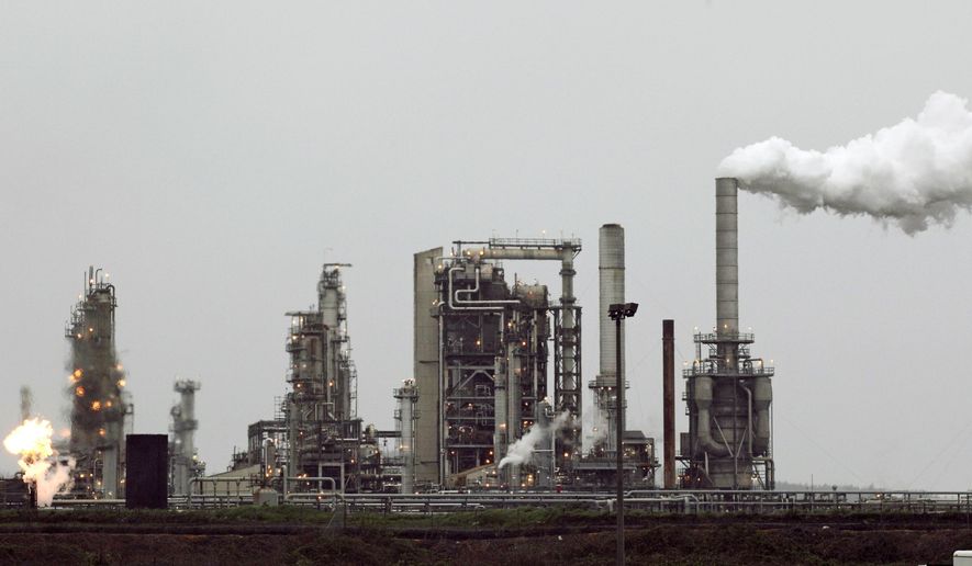 A Tesoro Corp. refinery, including a gas flare flame that is part of normal plant operations, in Anacortes, Wash. (AP Photo/Ted S. Warren, File)