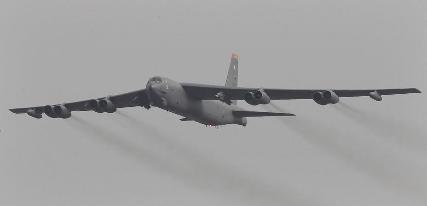 FILE - In this Sunday, Jan. 10, 2016, file photo, a U.S. Air Force B-52 bomber flies over Osan Air Base in Pyeongtaek, South Korea. China has labeled a recent mission by nuclear-capable U.S. B-52 bombers over the disputed South China Sea as "provocative" and says it will take all measures considered necessary to safeguard its rights and interests. (AP Photo/Ahn Young-joon, File)