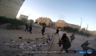 FILE - This photo posted on a file sharing website Jan. 11, 2017, by the Islamic State Group in Sinai, a militant organization, shows a deadly attack by militants on an Egyptian police checkpoint, in el-Arish, north Sinai, Egypt. In a switch from the past, Egypt’s military has begun arming Bedouin tribesmen in the Sinai Peninsula in the long-running fight against militants from the IS affiliate, tribesmen say. For years, the epicenter of the conflict has been in a triangle of towns and cities in the northeast corner of Sinai on the Mediterranean coast, and so far has been kept at a distance from tourist resorts at the southern end of the peninsula. (AP Photo) (Islamic State Group in Sinai via AP, File)