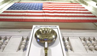 FILE- In this May 17, 2018, file photo an American flag hangs above the bell podium on the floor of the New York Stock Exchange. The U.S. stock market opens at 9:30 a.m. EDT on Thursday, Sept. 27 (AP Photo/Richard Drew, File)
