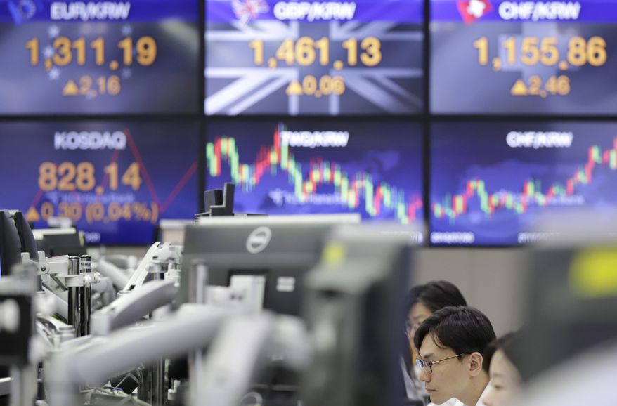 Currency traders work near screens showing the foreign exchange rates at the foreign exchange dealing room in Seoul, South Korea, Thursday, Sept. 27, 2018. Asian markets were mixed on Thursday after the U.S. Federal Reserve lifted its key interest rate as expected for the third time this year. (AP Photo/Lee Jin-man)
