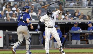 FILE - In this Saturday, Sept. 15, 2018 file photo, New York Yankees&#39; Andrew McCutchen reacts after striking out to end the seventh inning of a baseball game as Toronto Blue Jays catcher Danny Jansen, left, heads off the field at Yankee Stadium in New York. The most-heard sound at major league ballparks this year was &amp;quot;Strike three!&amp;quot; Strikeouts will exceed hits over a full season for the first time in major league history. (AP Photo/Bill Kostroun, File)