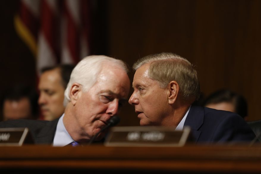 Senator John Cornyn (R-TX) and Senator Lindsey Graham (R-SC) talks as Dr. Christine Blasey Ford speaks before the Senate Judiciary Committee hearing on the nomination of Brett Kavanaugh to be an associate justice of the Supreme Court of the United States, on Capitol Hill in Washington, DC, USA, 27 September 2018. US President Donald J. Trump&#39;s nominee to be a US Supreme Court associate justice Brett Kavanaugh is in a tumultuous confirmation process as multiple women have accused Kavanaugh of sexual misconduct.  (Michael Reynolds/Pool Photo via AP)