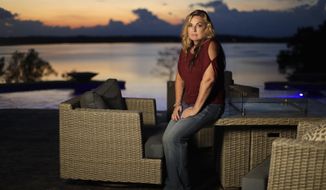 In this Sept. 25, 2018, photo, Heather Melton sits on a patio at her home in Big Sandy, Tenn., as the sun sets over the Big Sandy River. Heather and her husband, Sonny Melton, were in the final stages of building the home when Sonny died when he was shot while protecting Heather at the Route 91 Harvest Festival mass shooting in Las Vegas on Oct. 1, 2017. Now a year later, many survivors, who were already bonded through the music, have formed a tight-knit, encouraging community as they heal, support and remember. They call themselves &amp;quot;Country Strong.&amp;quot; (AP Photo/Mark Humphrey)