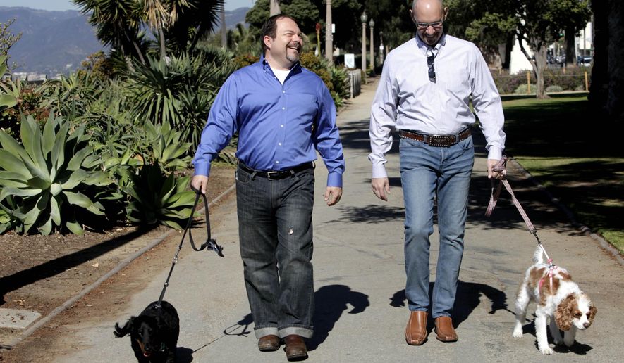 FILE - In this Feb. 23, 2012, file photo, Steven May, right, walks with his dog, Winnie beside his attorney, David Pisarra, with his dog, Dudley in Santa Monica, Calif. California courts could be going to the dogs, and maybe the cats too, under a new law signed by Gov. Jerry Brown. The law, signed Thursday, Sept. 28, 2018, gives judges the discretion of applying rules similar to those in child-custody cases when determining who gets the family pet following a divorce. It takes effect Jan. 1, 2019. (AP Photo/Nick Ut, File)