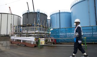 FILE - In this Feb. 23, 2017, file photo, an employee walks past storage tanks for contaminated water at the tsunami-crippled Fukushima Dai-ichi nuclear power plant of the Tokyo Electric Power Co. (TEPCO) in Okuma town, Fukushima prefecture, Japan. The operator of Japan&#39;s wrecked Fukushima nuclear plant said Friday, Sept. 28, 2018, that much of the radioactive water stored at the plant isn&#39;t clean enough and needs further treatment if it is to be released into the ocean. (Tomohiro Ohsumi/Pool Photo via AP, File)